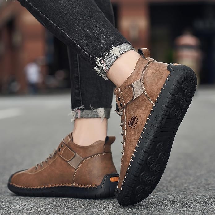 Brown leather shoes with black soles worn by a person on a blurred street background
