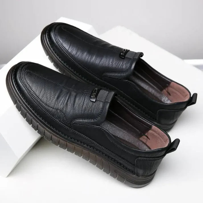Pair of black leather shoes on a white background