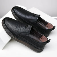 Pair of black leather shoes on a white background