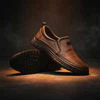 Pair of brown slip-on shoes on a white background