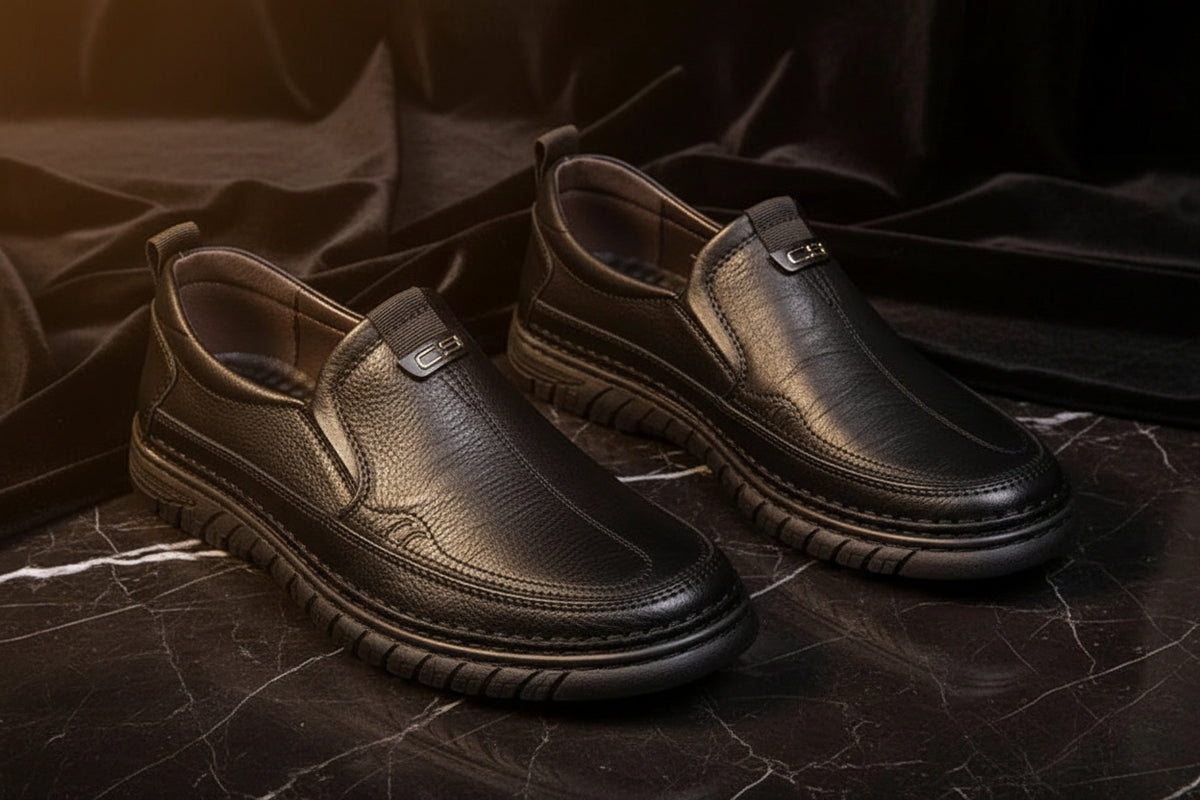 Pair of black leather shoes on a light gray background