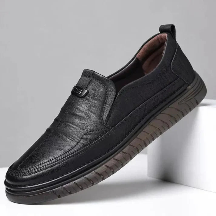 Black leather shoe on a light gray background