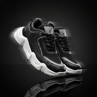 Black and gray sneakers with white soles on a white background
