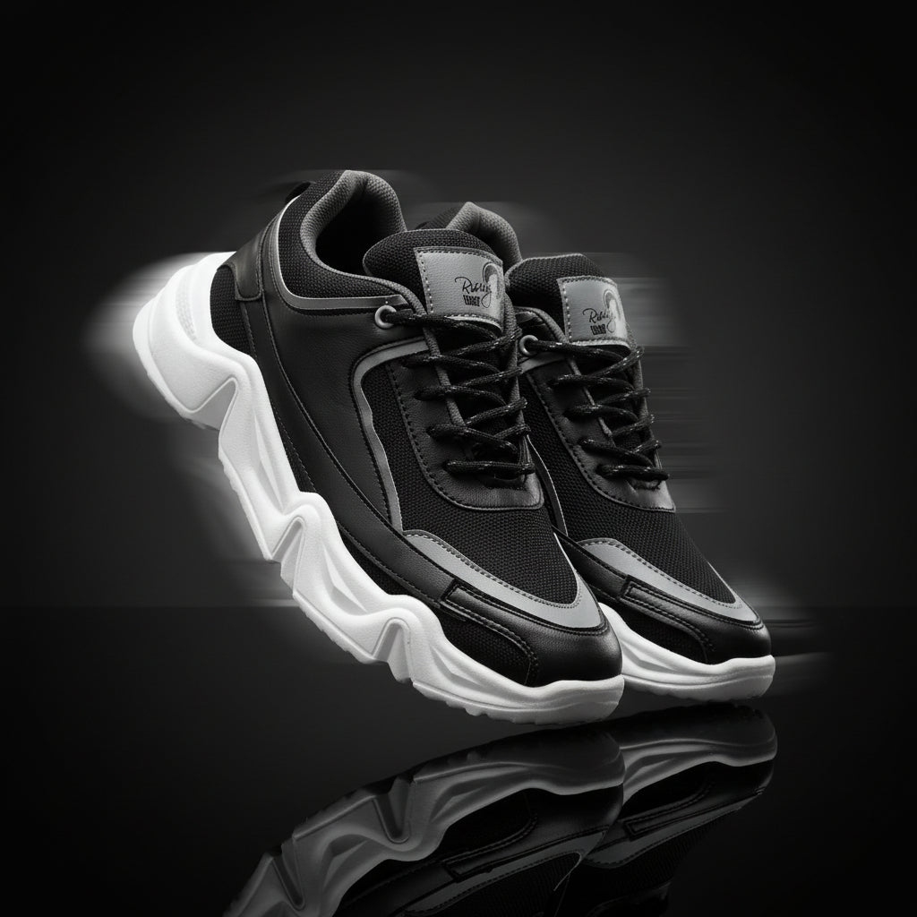 Black and gray sneakers with white soles on a white background