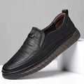 Black leather shoe on a light gray background