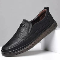 Black leather shoe on a light gray background