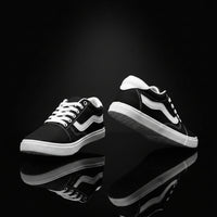 Black and white sneakers shown from the side on a white background