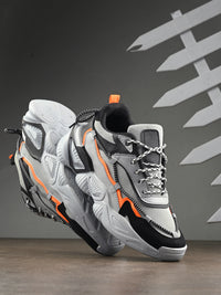 Gray and black sneakers with orange accents on a dark background