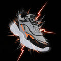Gray and black sneaker with orange accent on a white background