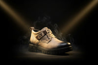 Tan shoe with black sole on a white background