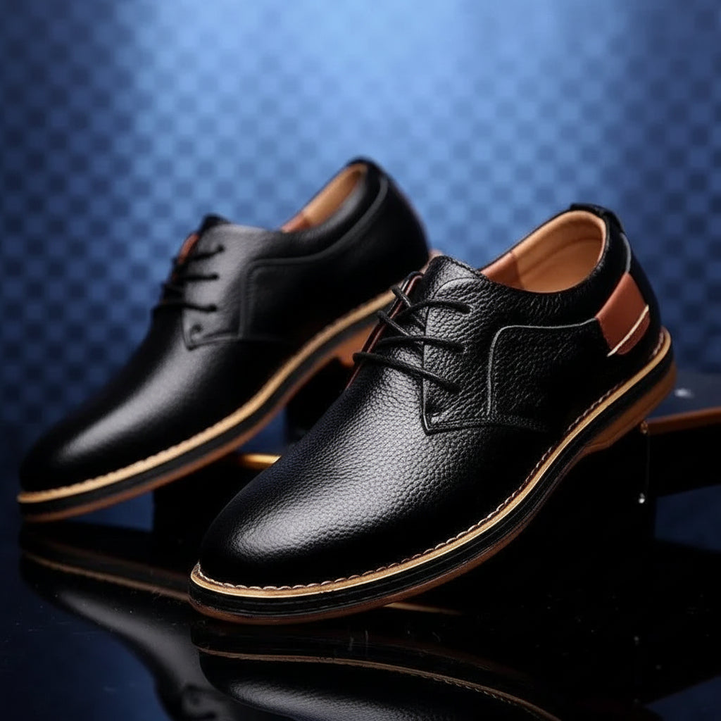 Black leather shoes on a reflective surface with a blue textured background